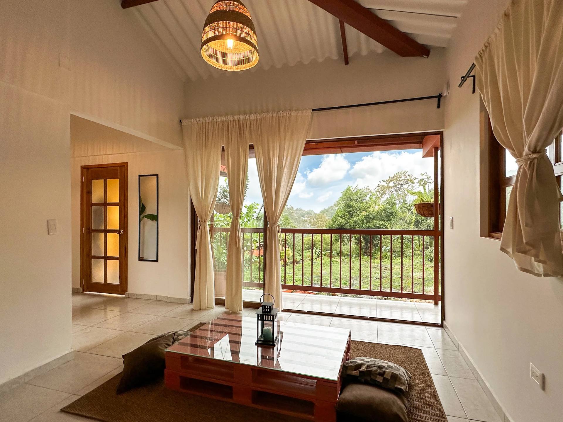 Queen Suite living space with glass doors onto the garden (El Nido Andino, boutique hotel in La Mesa)